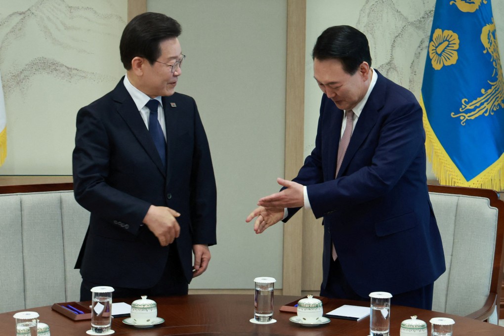 South Korean President Yoon Suk-yeol (right) with Lee Jae-myung, head of the main opposition Democratic Party, before their talks at the presidential office in Seoul on Monday. Photo: Yonhap via Reuters