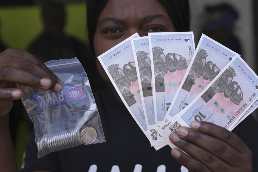 A woman holds the new Zimbabwean banknotes and coins called the ZiG. Photo: AP