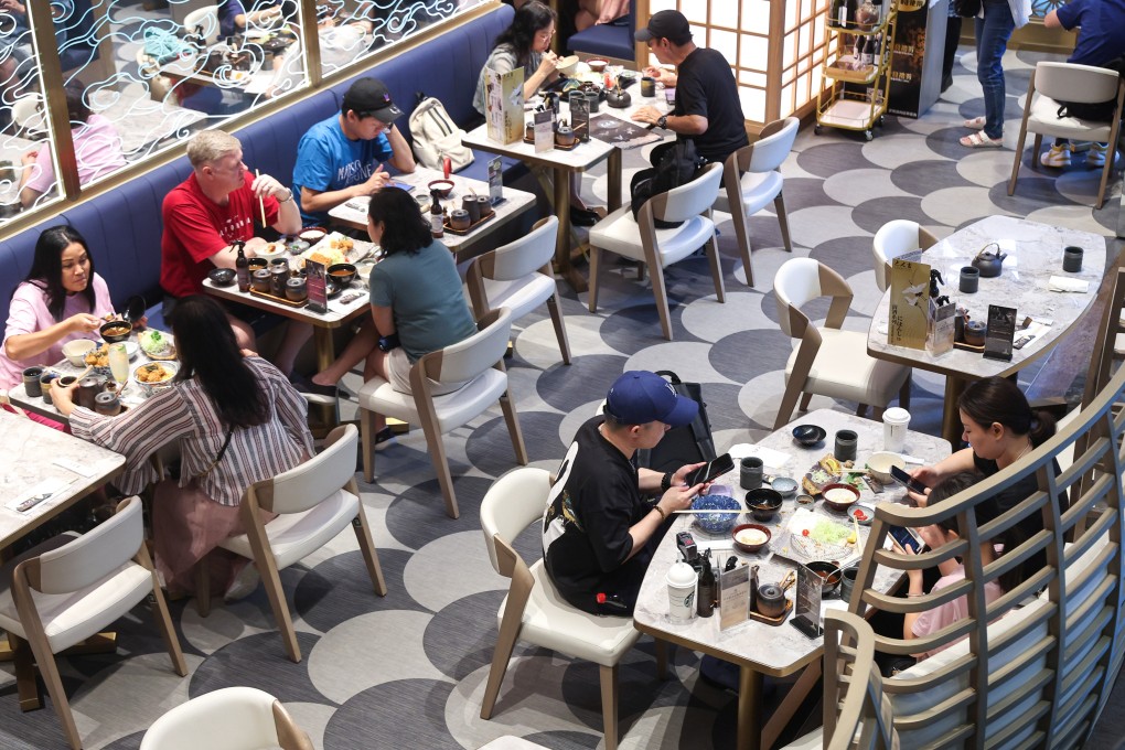 Diners eat lunch at a restaurant in Mong Kok. The city is expected to welcome at least 800,000 mainland Chinese visitors over the break. Photo: Edmond So