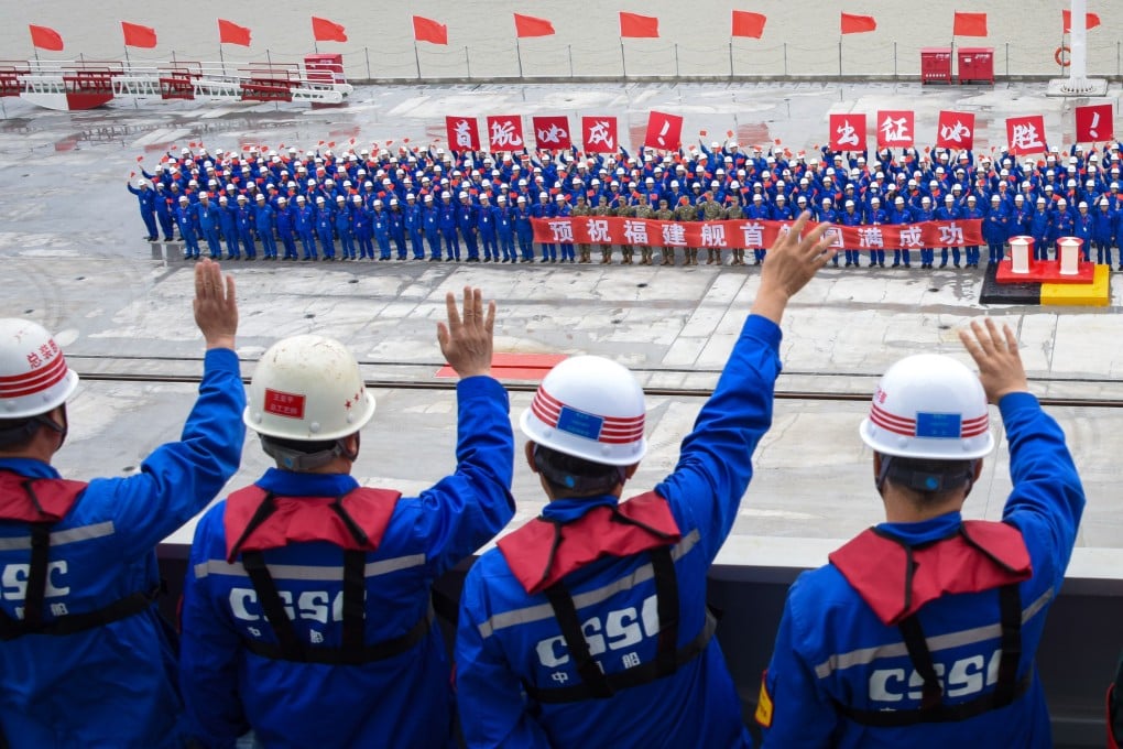 Well-wishers wave as China’s Fujian aircraft carrier leaves its dock in Shanghai on its maiden voyage to begin sea trials which are expected to take about a year. Photo: Xinhua
