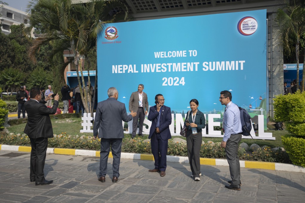 Participants of Nepal Investment Summit take photos during the first day of the event in Kathmandu. Photo: AP