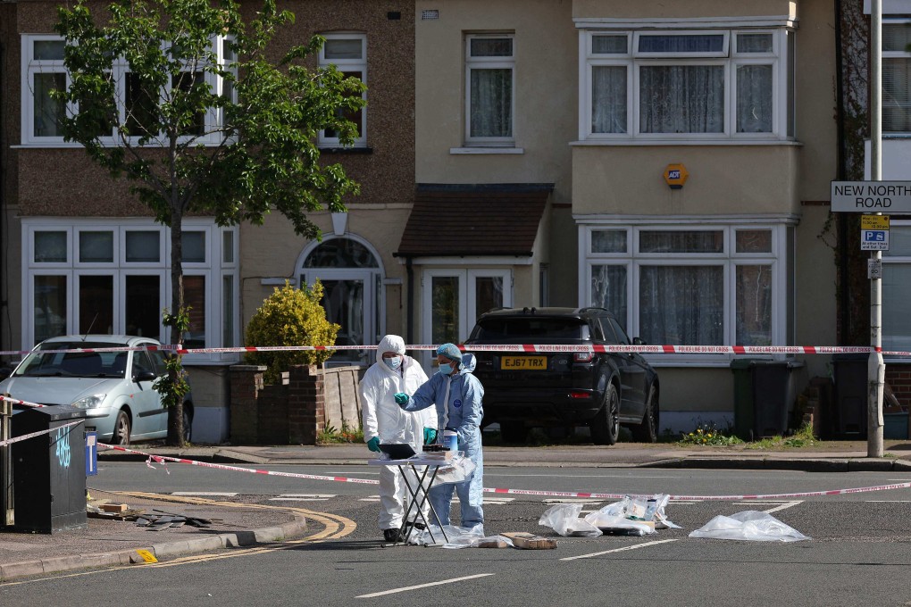 Police forensic officers examine the crime scene in Hainault, east of London. Photo: AFP