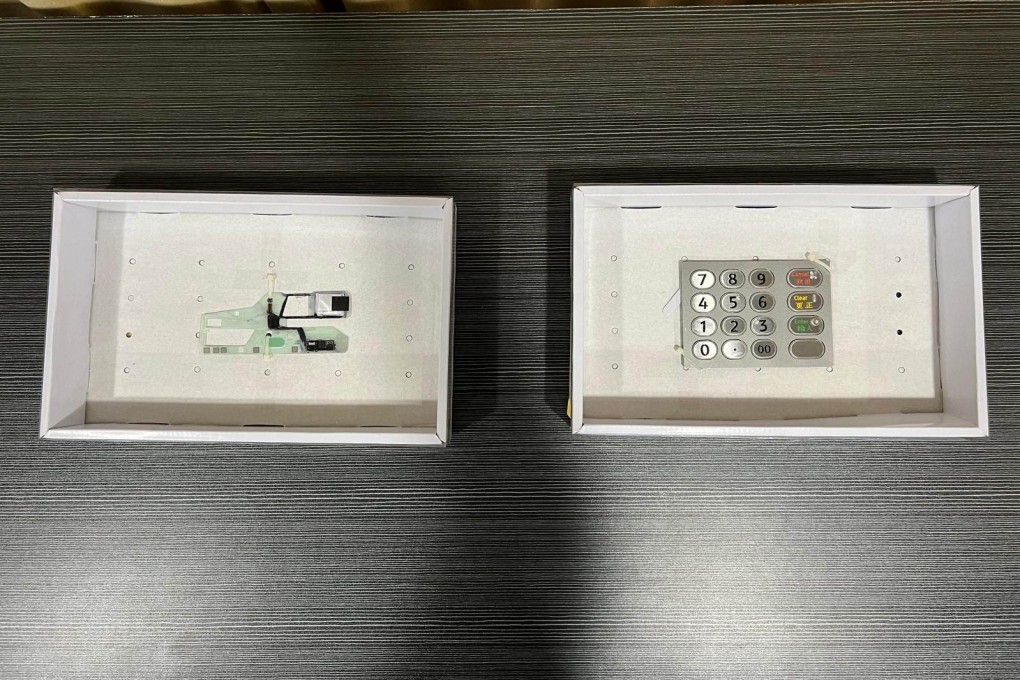 Police display the card reader and false keypad installed on a deposit machine in Mong Kok. Photo: Handout