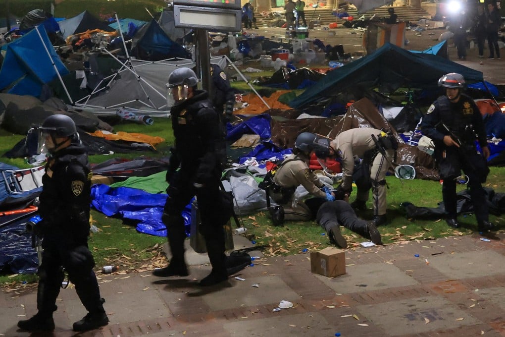 Law enforcement officers detain a demonstrator, as they clear out the protest encampment in support of Palestinians at the University of California Los Angeles. Photo: Reuters