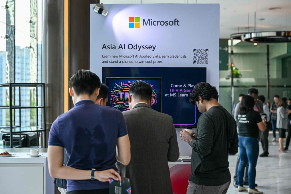Participants check a Microsoft booth Microsoft Build’s AI Day in Kuala Lumpur. Microsoft pledged a US$2.2 billion investment in artificial intelligence and cloud computing in Malaysia to help develop the country’s AI infrastructure. Photo: AFP