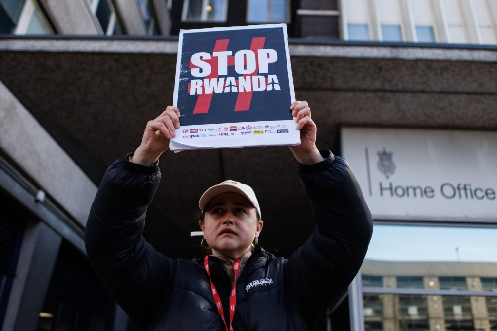 An activist protests against the British government’s Rwanda deportation scheme outside a Home Office immigration reporting centre in London on Monday. Photo: EPA-EFE