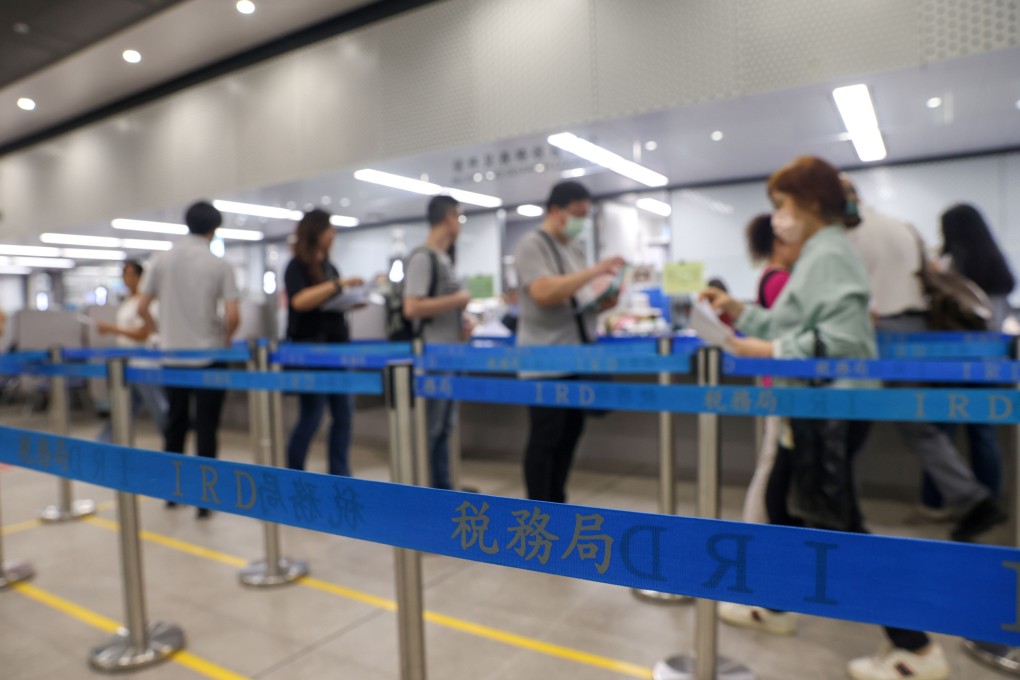 Hong Kong residents line up at the Inland Revenue Centre. Takings from profits tax, which accounted for half of the total revenue in the last financial year, declined by 2 per cent. Photo: Yik Yeung-man