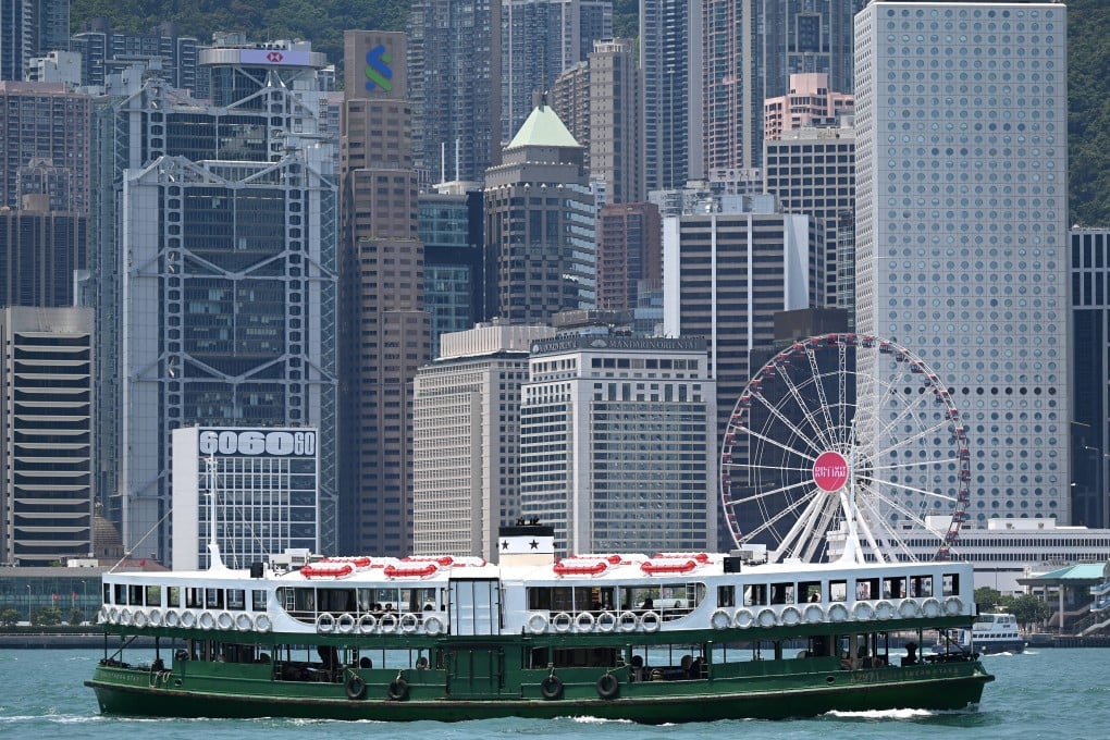 A Star Ferry crosses Victoria Harbour in Hong Kong to the backdrop of buildings housing banks and financial institutions on May 4, 2022. Photo: AFP