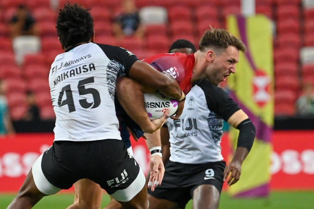 Great Britain’s Harry Glover takes the fight to Fiji, but the Brits could face a battle for world series survival. Photo: AFP