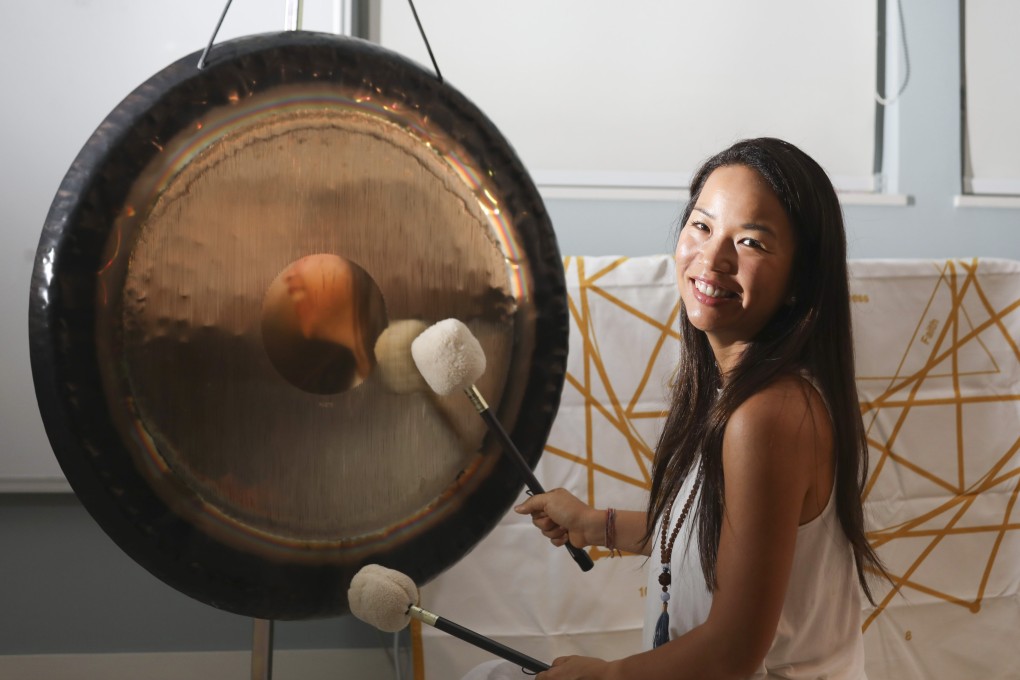 Melisa Fu O’Connor shows how she beats a gong ahead of a gong bath session in Sheung Wan, Hong Kong. She, a fellow therapist and a client extol the benefits of sound therapy. Photo: Xiaomei Chen