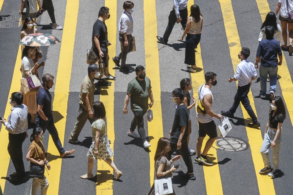 Pedestrians cross a street in Central district, Hong Kong, on August 1, 2022. To thrive in the evolving landscape, the city must focus on redefining its identity to attract a diverse pool of talent. Photo: Jonathan Wong