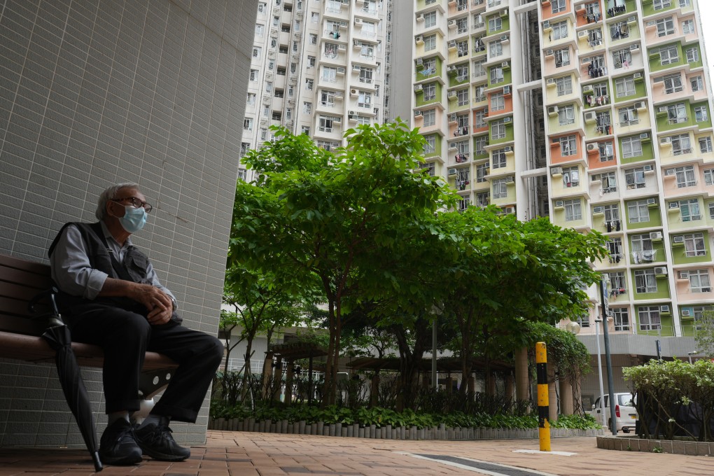A man sits outside public housing at Cheung Sha Wan on May 11, 2023. The average waiting time for a public rental flat now stands at nearly six years. Photo: Sam Tsang