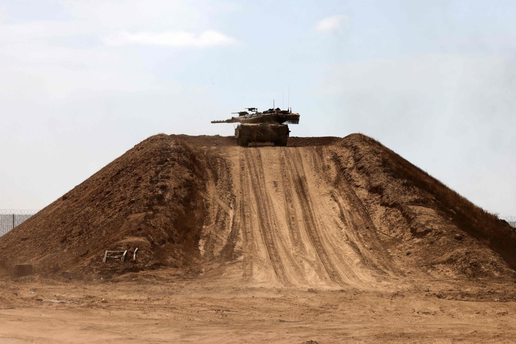 An Israeli tank atop a sand mound near the border with the Gaza Strip. Photo; AFP