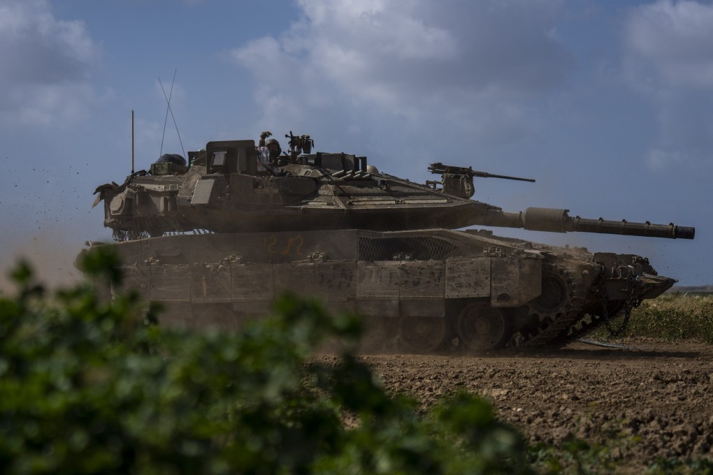 Israeli soldiers drive a tank on the border with Gaza Strip. Israel and Hamas appear to be seriously negotiating an end to the war in Gaza and the return of Israeli hostages. Photo: AP