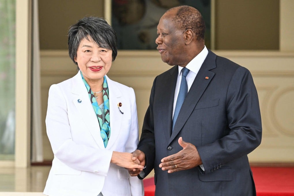 Japanese Foreign Minister Yoko Kamikawa shakes hands with Ivory Coast President Alassane Ouattara at his residence in Abidjan on Monday. Photo: AFP