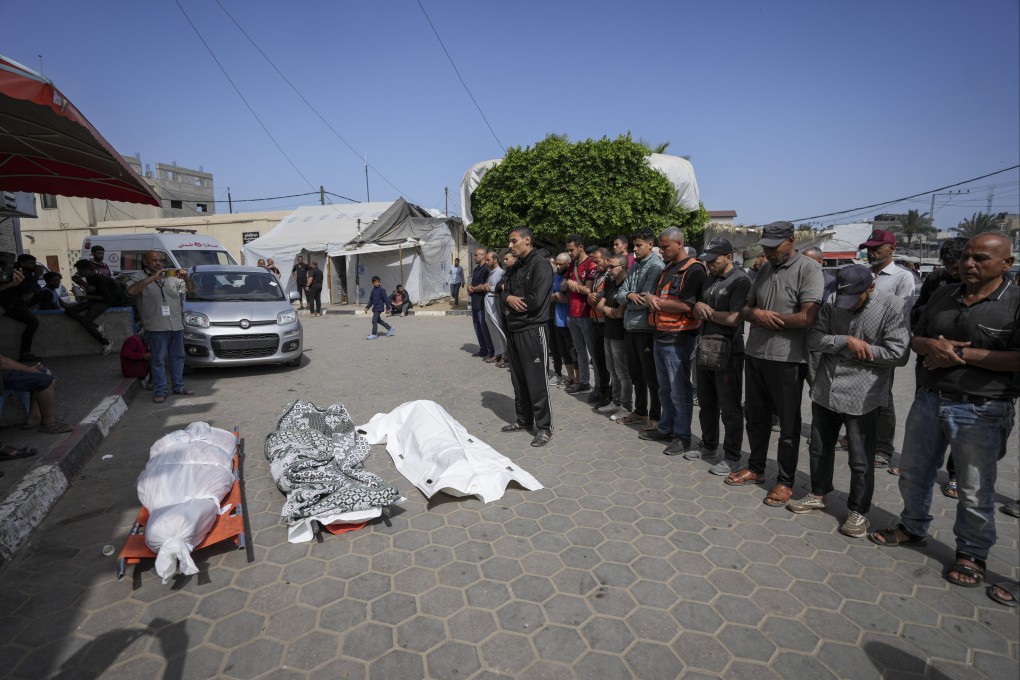 Palestinians pray next to the bodies of their relatives who were killed in an Israeli airstrike in Gaza Strip, at the Al Aqsa hospital. Photo: AP