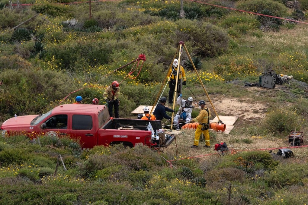 A rescuer descends into a waterhole where human remains were found near La Bocana Beach in Ensenada, Mexico’s Baja California state, on May 3. Photo: AFP