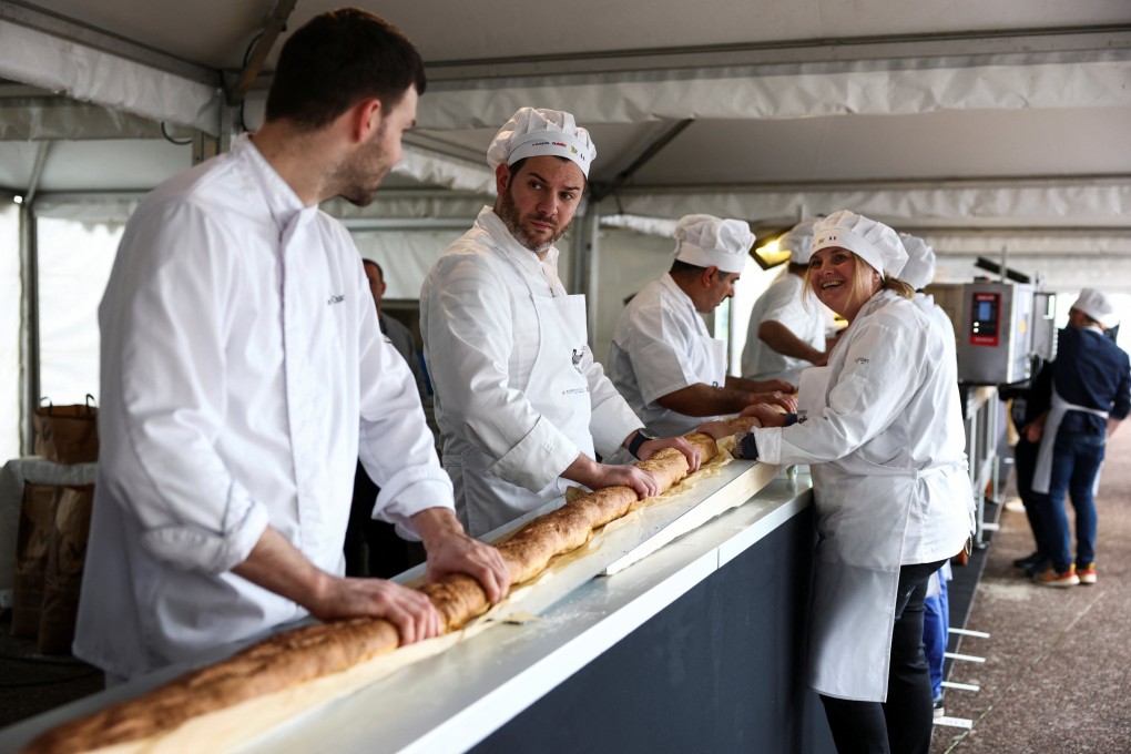 The world’s longest baguette being made in Suresnes near Paris, France on Sunday. Photo: Reuters
