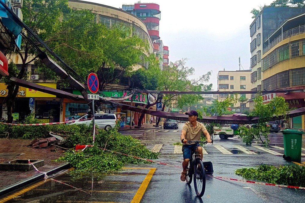 A cyclist rides past fallen debris and trees in the aftermath of heavy storms in Qingyuan city in southern China’s Guangdong province Monday, April 22, 2024. Cat bonds could help China develop a multilayer risk-transfer mechanism. Photo: AP