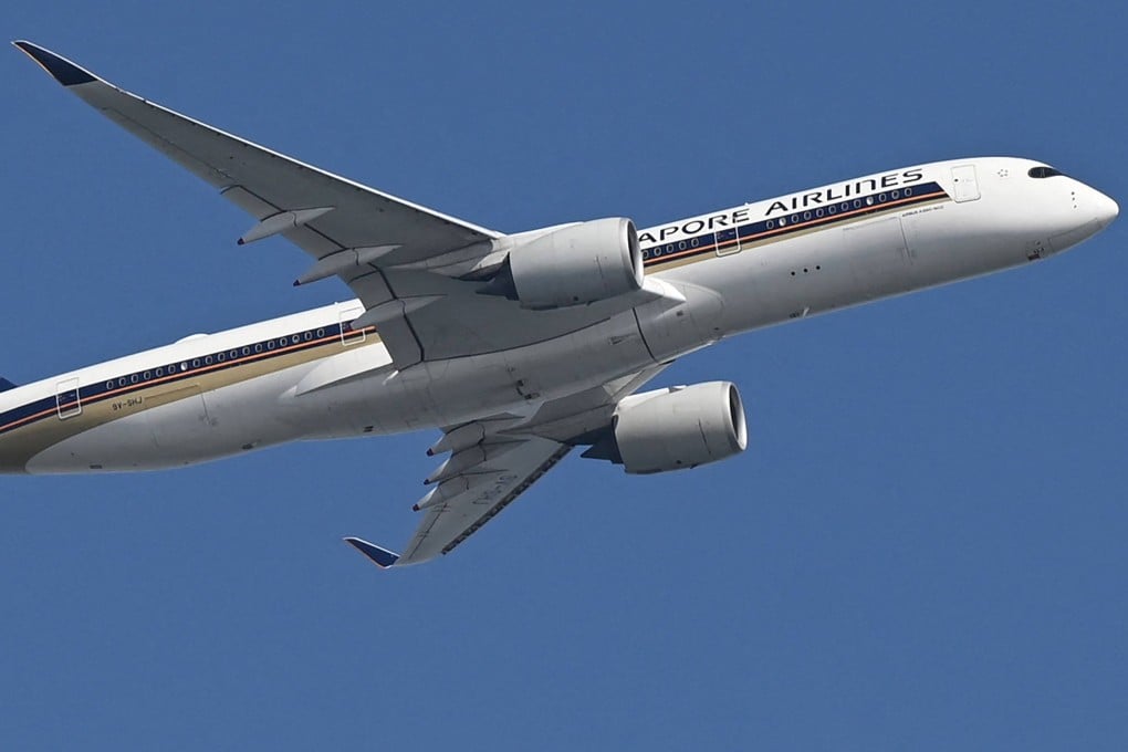 A Singapore Airlines aeroplane flies after take off from Changi Airport in Singapore on February 20. Photo: AFP
