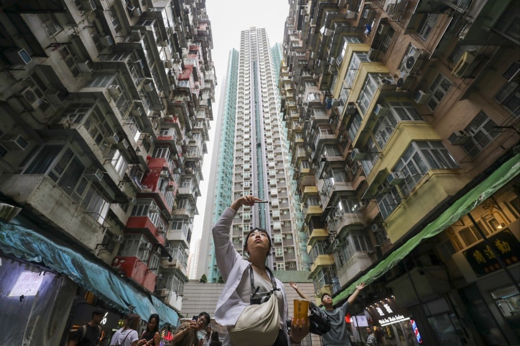 Tourists take pictures at Yick Cheong Building, also known as ‘monster building’, in Quarry Bay. Photo: Xiaomei Chen