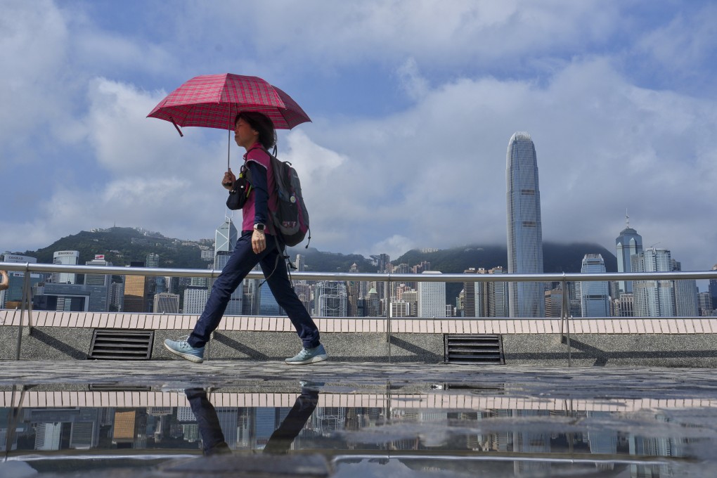 A tourist takes a stroll along the Tsim Sha Tsui promenade during the Labour Day golden week break. Photo: Elson Li