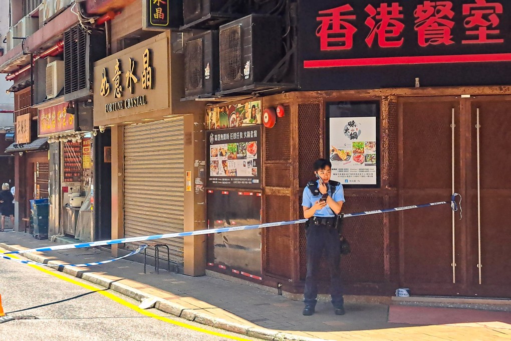 A police officer on duty at the site where a woman was bundled into a car by two men in Tsim Sha Tsui. Photo: Handout