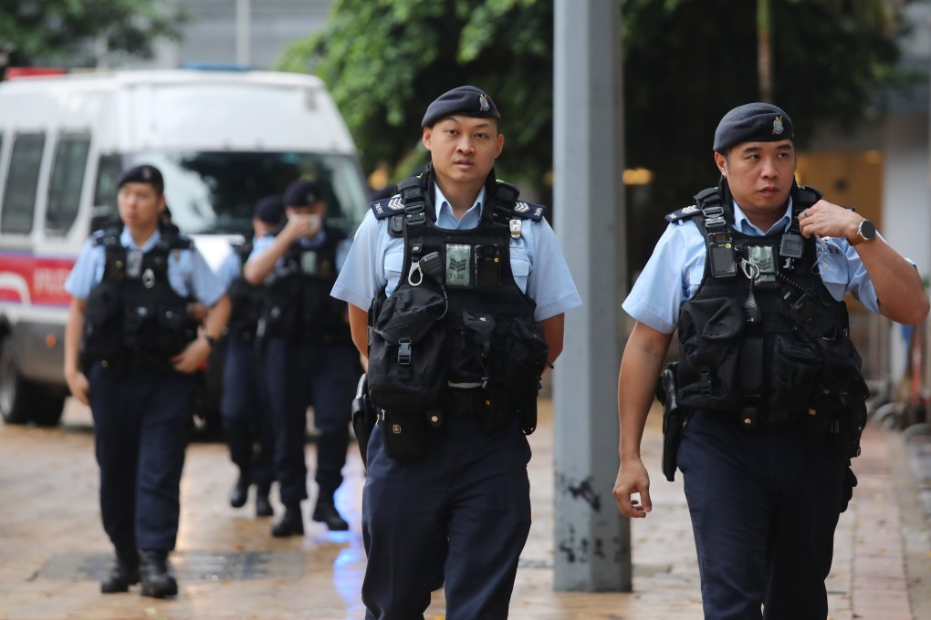Police officers on patrol near the High Court in Admiralty before the trial session of “Dragon Slaying” team members. Xiaomei Chen