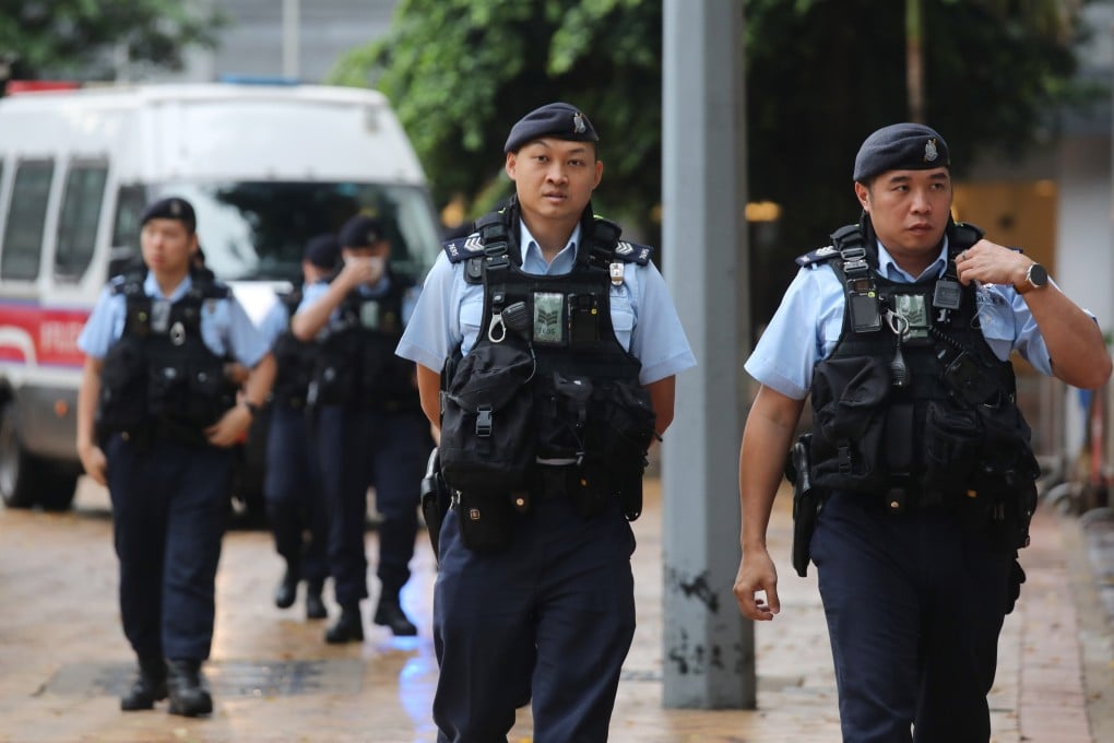 Police officers on patrol near the High Court in Admiralty before the trial session of “Dragon Slaying” team members. Xiaomei Chen