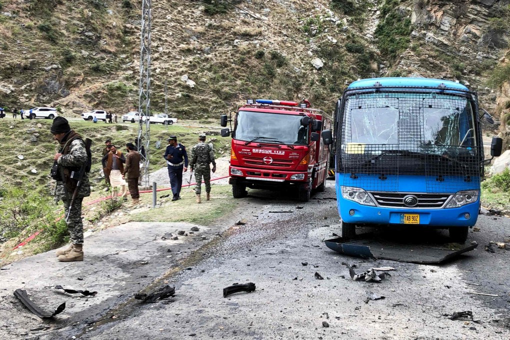 Security personnel inspect the site of a suicide attack in Pakistan that killed five Chinese engineers. Photo: AFP