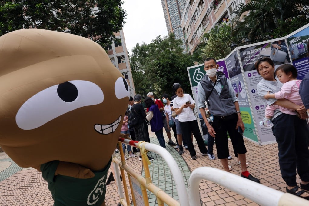 A “Big Waster” mascot interacts with residents of the Moon Lok Dai Ha estate in Tsuen Wan on April 9. Photo: Jelly Tse