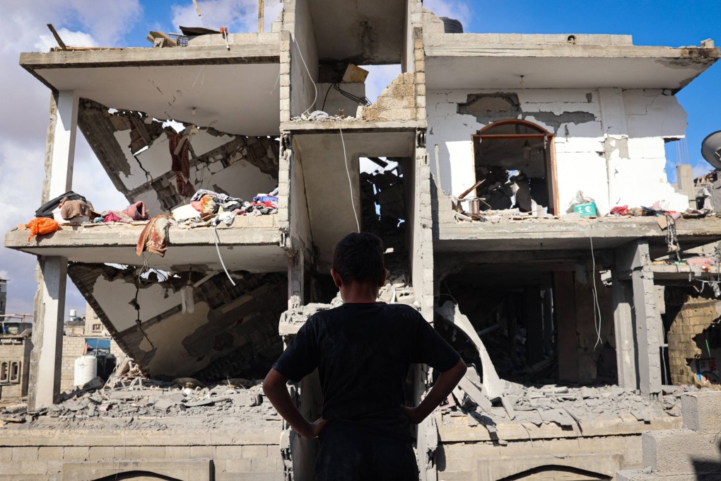 A Palestinian youth stands in front of a destroyed building following Israeli bombardment of Rafah’s Tal al-Sultan district in the southern Gaza Strip. Photo: AFP