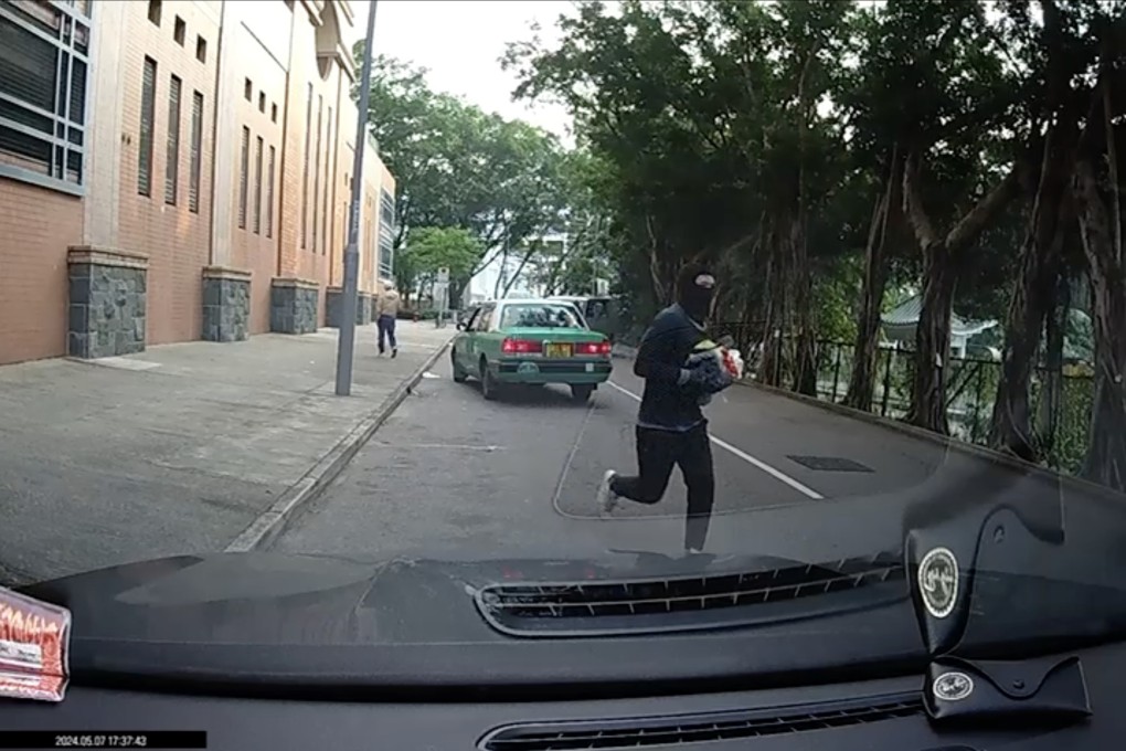 Dashcam footage shows one of the robbers making off with the stolen goods. Photo: Handout