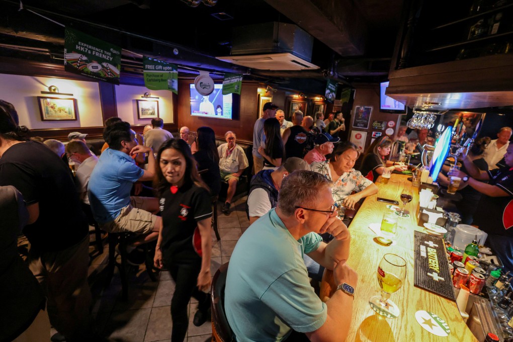Customers enjoy a drink in a Wan Chai bar, but times are hard for some businesses. Photo: Dickson Lee