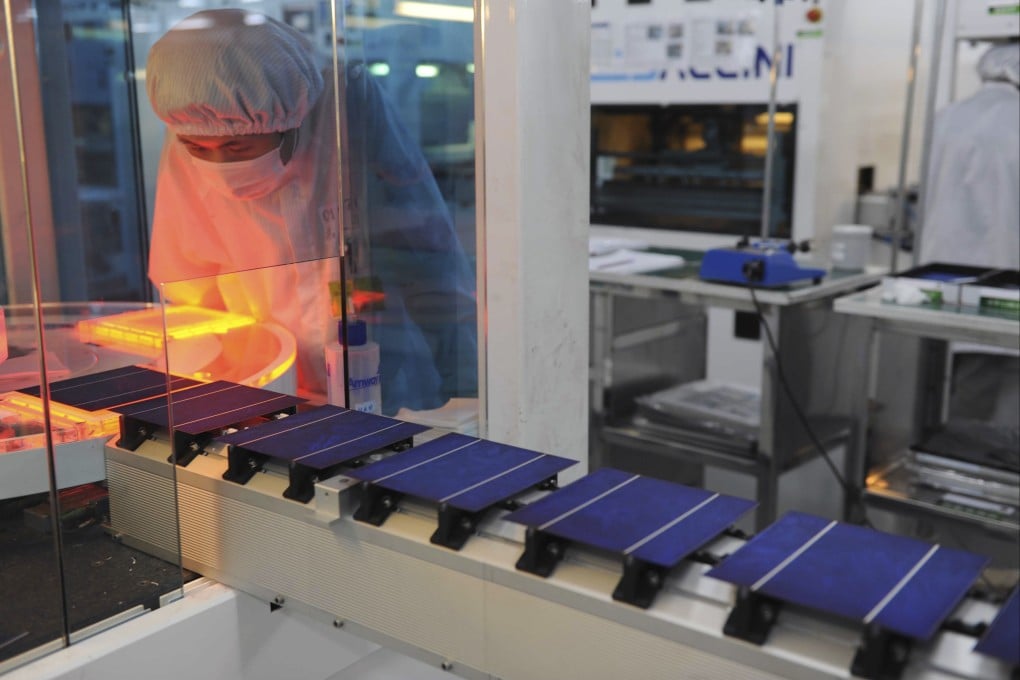 A worker monitors a solar panel production line at a factory owned by Astronergy in Hangzhou, China’s Zhejiang province. File Photo: AP