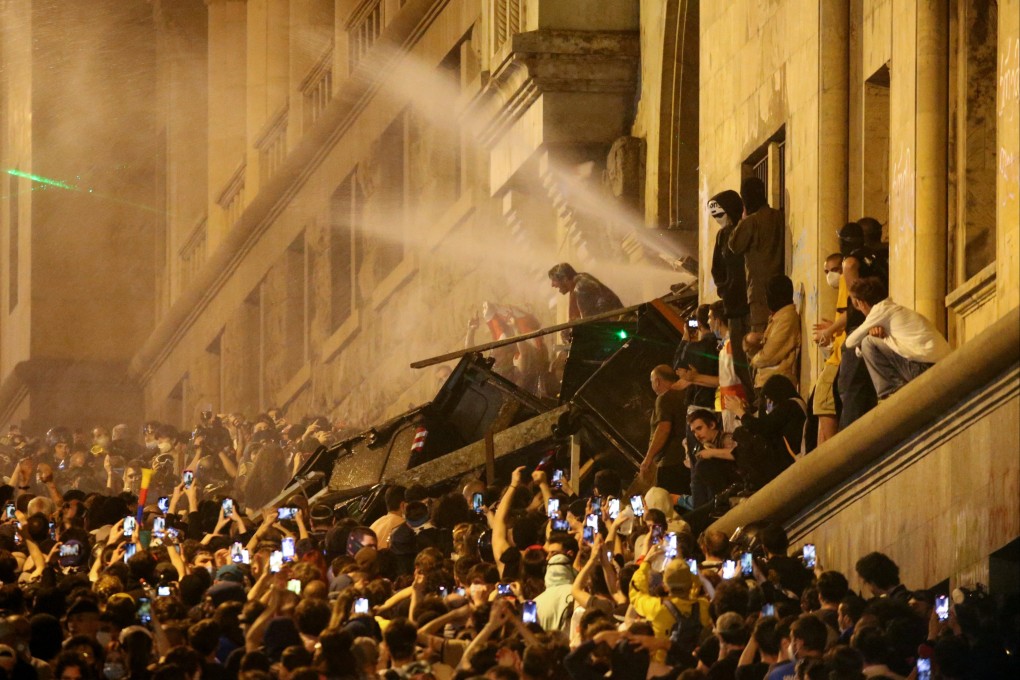 Protesters barricade the entrance of Parliament during a rally to protest against a bill on “foreign agents”, in Tbilisi, Georgia on May 2. Photo: Reuters