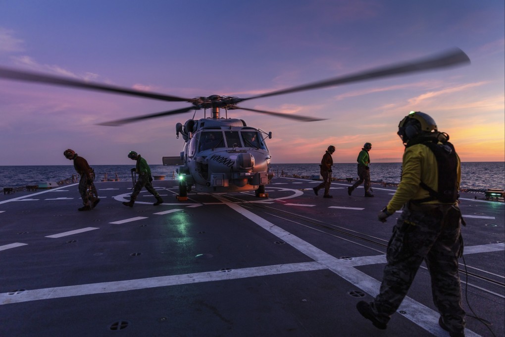 A helicopter prepares to take off from the deck of HMAS Hobart. Photo: AP