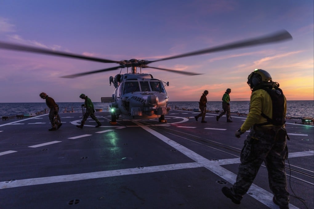 A helicopter prepares to take off from the deck of HMAS Hobart. Photo: AP