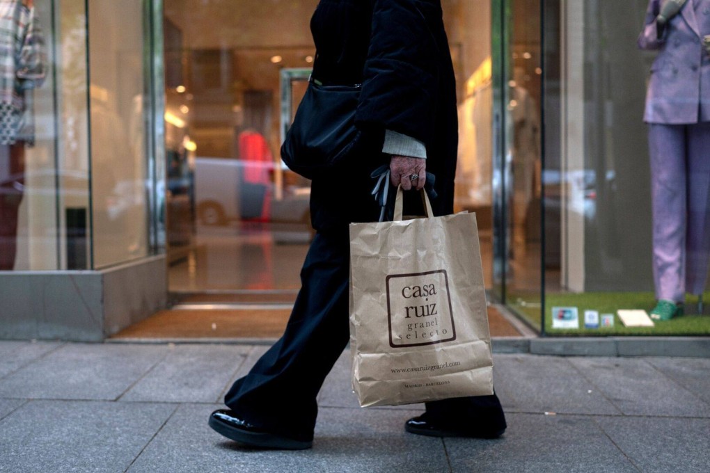 A shopper carries a bag in central Madrid. Since the UK scrapped a tax rebate scheme for tourists, many travellers have instead visited the Spanish capital to take advantage of tax breaks. Photo: Bloomberg