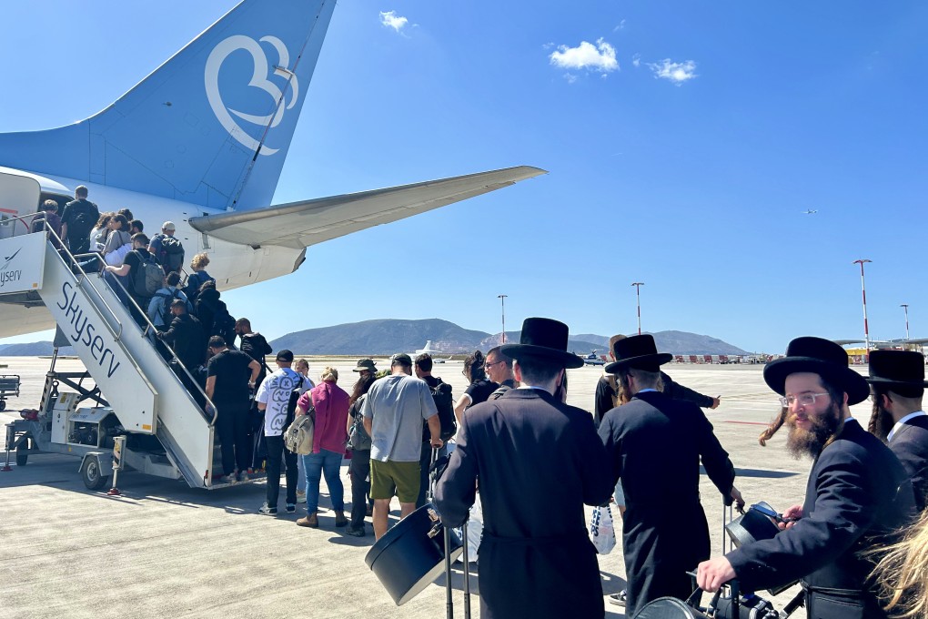 Passengers stand on the baking hot tarmac at Athens International Airport, Greece, where they are made to wait for 30 minutes before boarding their flight to Israel’s Ben Gurion Airport, on May 3, 2024. Photo: Ian Neubauer
