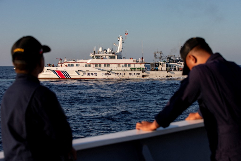 Crew on board a Philippine Coast Guard vessel keep watch as a Chinese coastguard vessel blocks their way to a resupply mission at Second Thomas Shoal in the South China Sea in March. Photo: Reuters