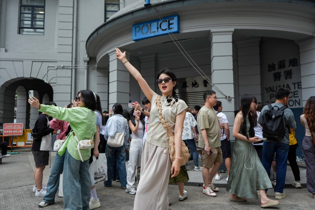 Tourists pose for photos outside Yau Ma Tei Police Station during the recent “golden week” break. Photo: Eugene Lee