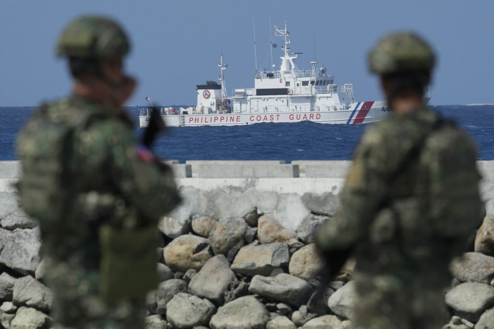 A Philippine coastguard ship secures an area at the Manila-occupied Thitu Island in the disputed South China Sea. Photo: AP