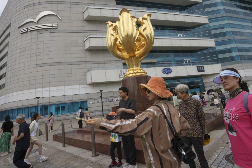 Tourists at Golden Bauhinia Square. An industry head says the latest update is a “strategic move” as it will enhance Hong Kong’s role as an aviation hub. Photo: Jonathan Wong