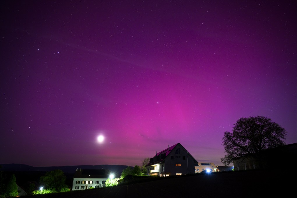 The Northern lights glow in the night sky above the village of Daillens, Switzerland, on May 11. Photo: EPA-EFE