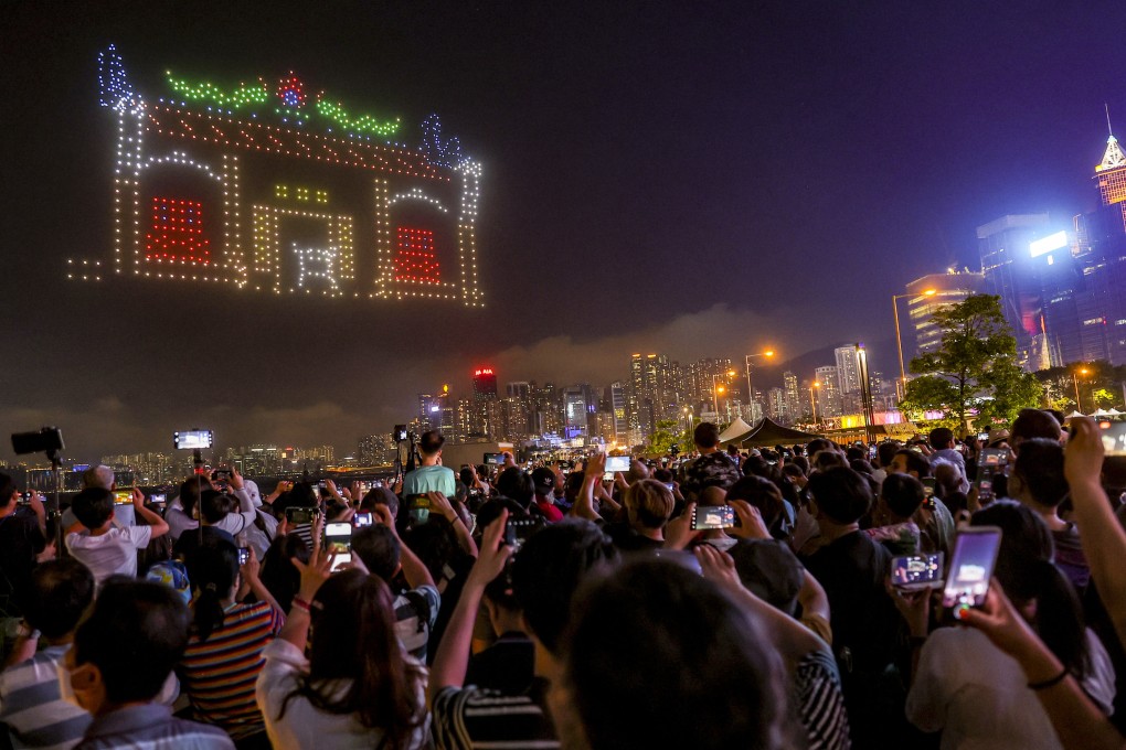 Residents and tourists watch Saturday night’s drone show. Photo: Edmond So