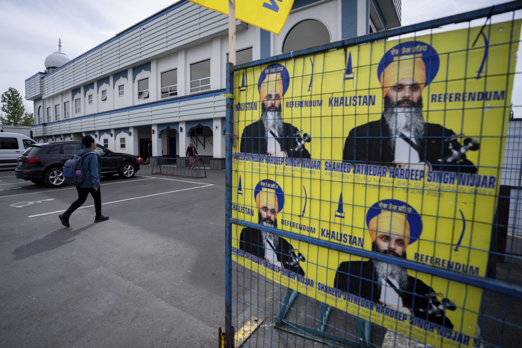 A person walks past images of Hardeep Singh Nijjar at the Guru Nanak Sikh Gurdwara in Surrey, British Columbia, Canada, on May 3. Photo: Canadian Press via AP