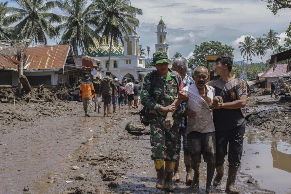 Rescuers evacuate an injured man on Sunday following a flash flood in West Sumatra, Indonesia. Dozens of people were killed after heavy rain triggered floods and ‘cold lava flow’, the authorities said. Photo: EPA-EFE