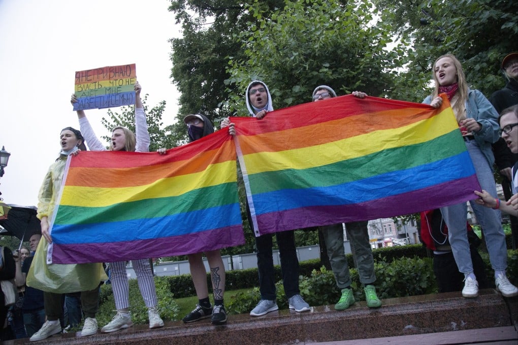 LGBTQ activists wave flags during a rally in Moscow. Russia does not ban homosexuality itself but because it cannot be discussed, it is a social taboo. Photo: AP