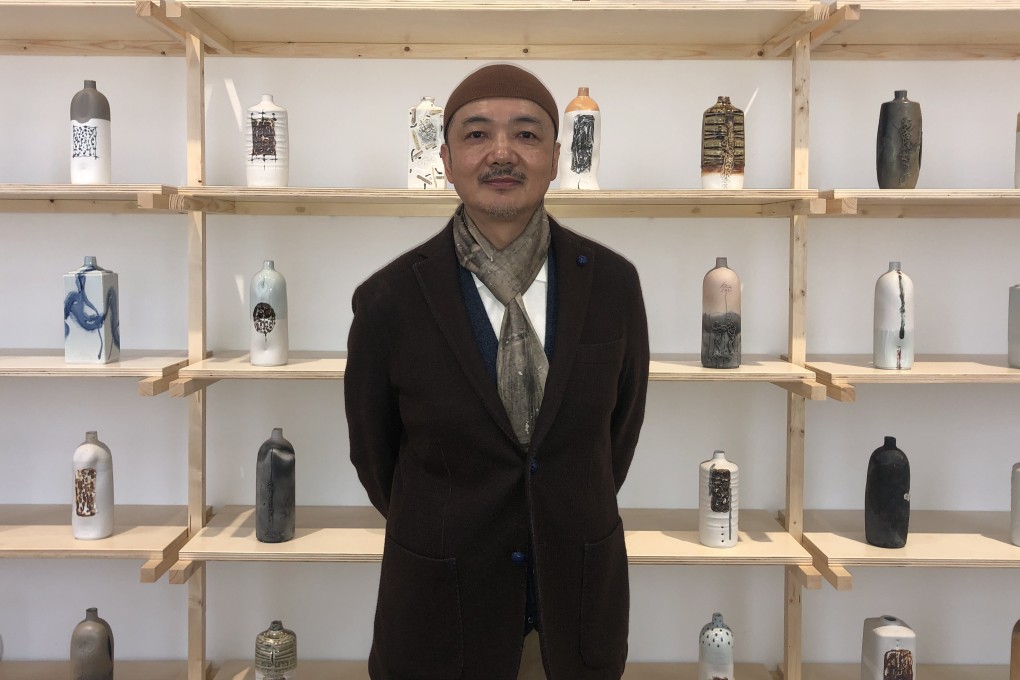 Chinese contemporary artist Bai Ming stands in front of his “Appliance: Form and Process” (2004) at a retrospective of his career at the National Gallery of Modern and Contemporary Art in Rome, Italy. Photo: Enid Tsui